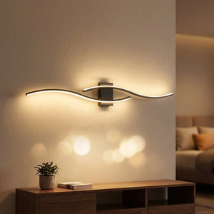 Applique murale noire double courbe LED 80cm allumée au dessus d'un meuble bas