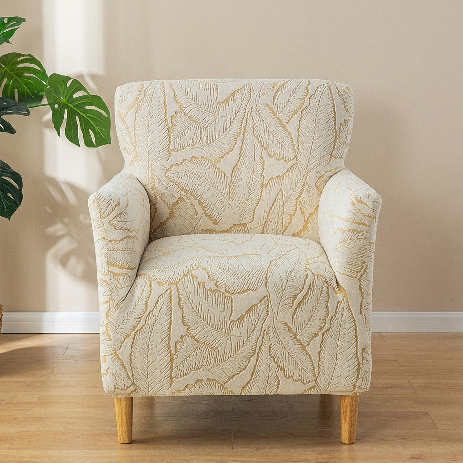 Housse de fauteuil doré à motif de feuilles en jacquard sur un fauteuil club