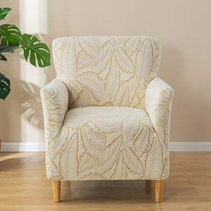 Housse de fauteuil doré à motif de feuilles en jacquard sur un fauteuil club