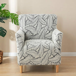 Housse de fauteuil gris à motif de feuilles en jacquard sur un fauteuil club