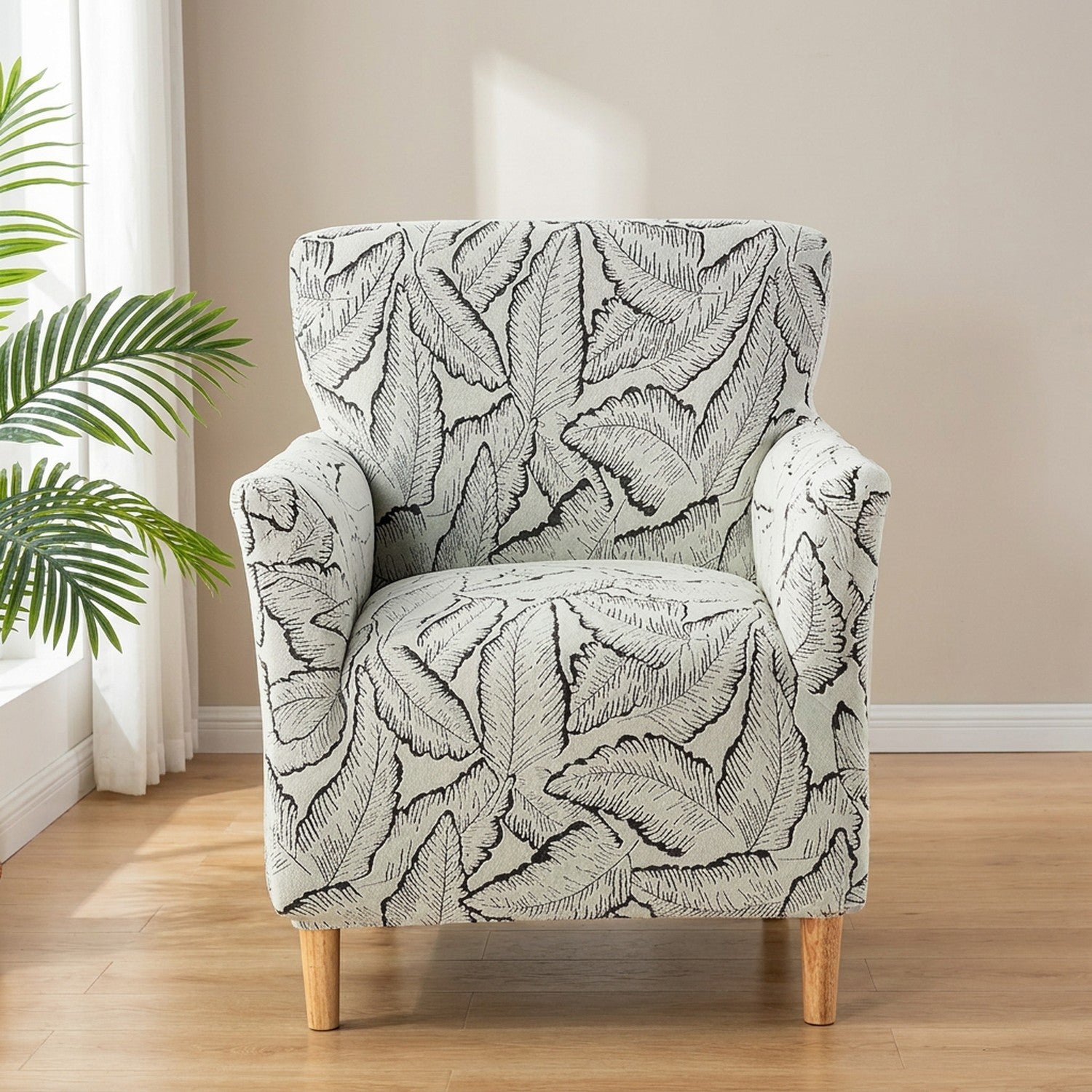 Housse de fauteuil noir à motif de feuilles en jacquard sur un fauteuil club