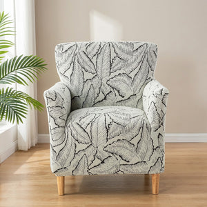 Housse de fauteuil noir à motif de feuilles en jacquard sur un fauteuil club
