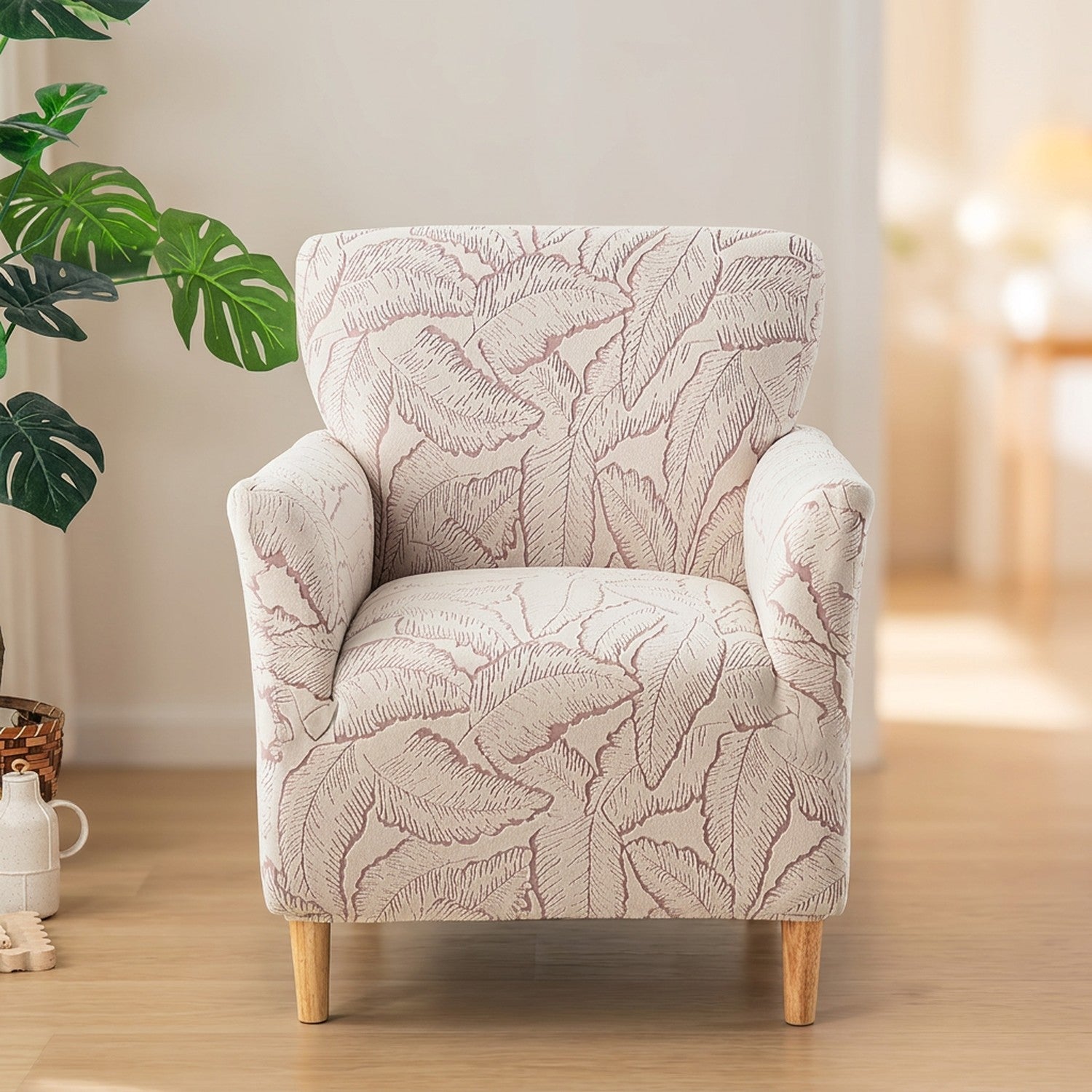 Housse de fauteuil rose à motif de feuilles en jacquard sur un fauteuil club