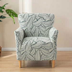 Housse de fauteuil vert à motif de feuilles en jacquard sur un fauteuil club