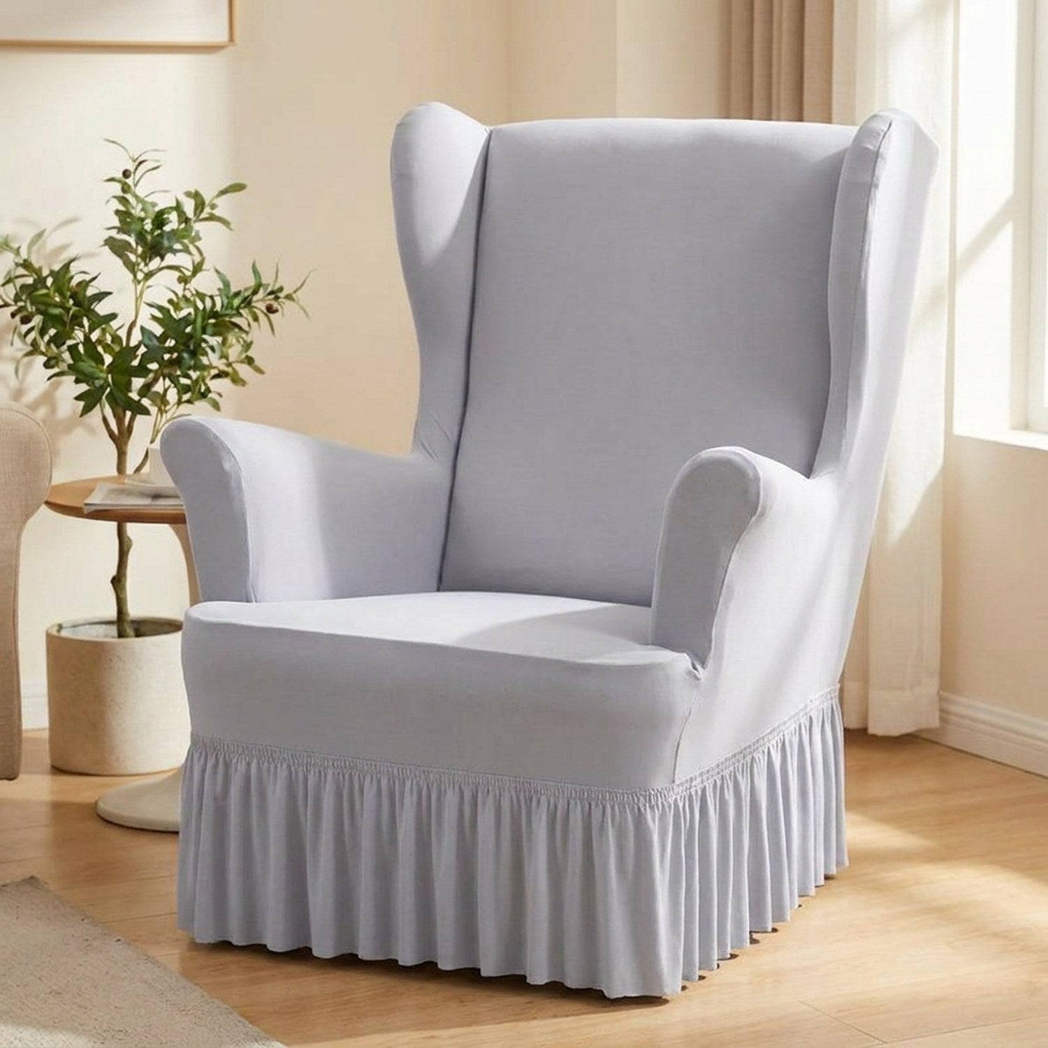 Housse de fauteuil à oreilles gris clair avec jupe à volants