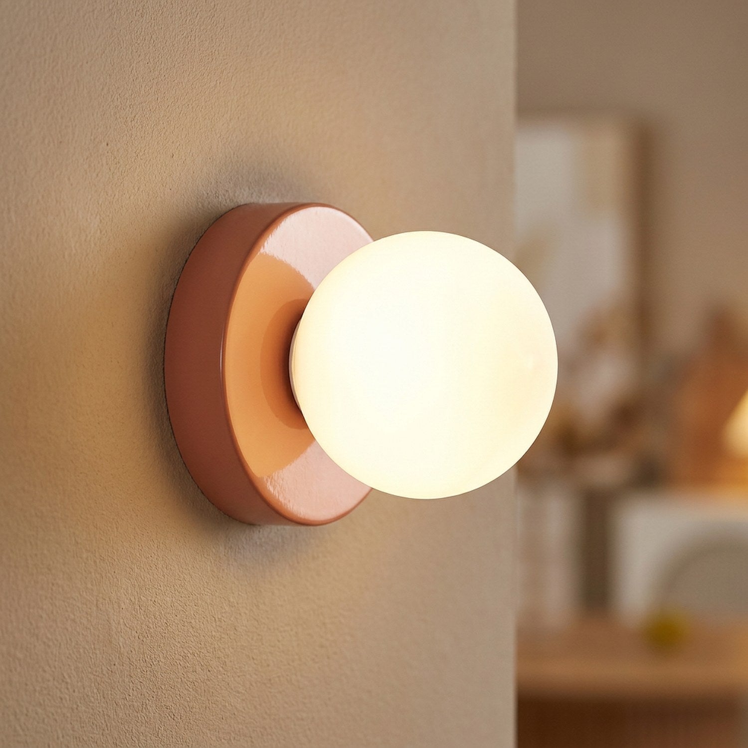 Applique murale terracotta avec globe en verre allumé gros plan