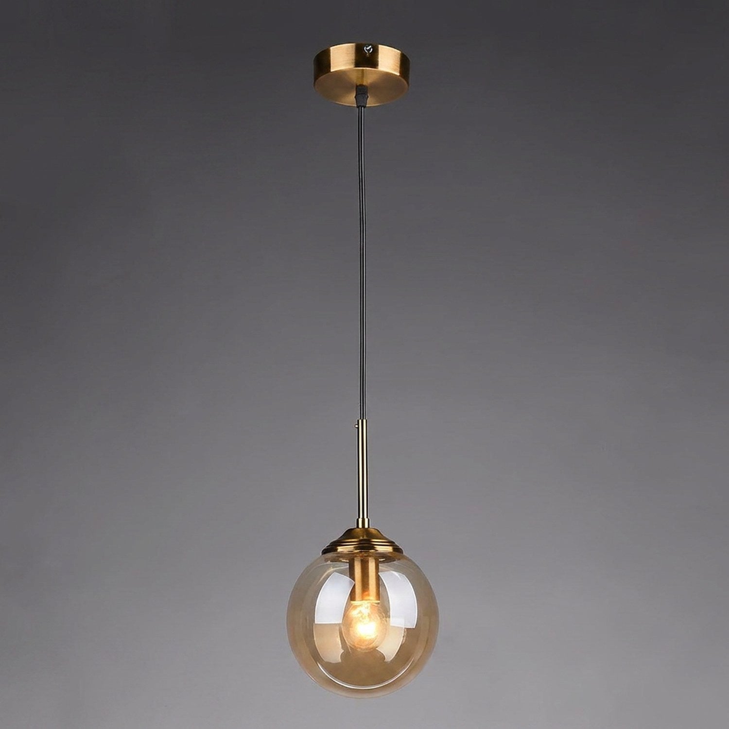 Suspension globe en verre ambre avec monture laiton dore