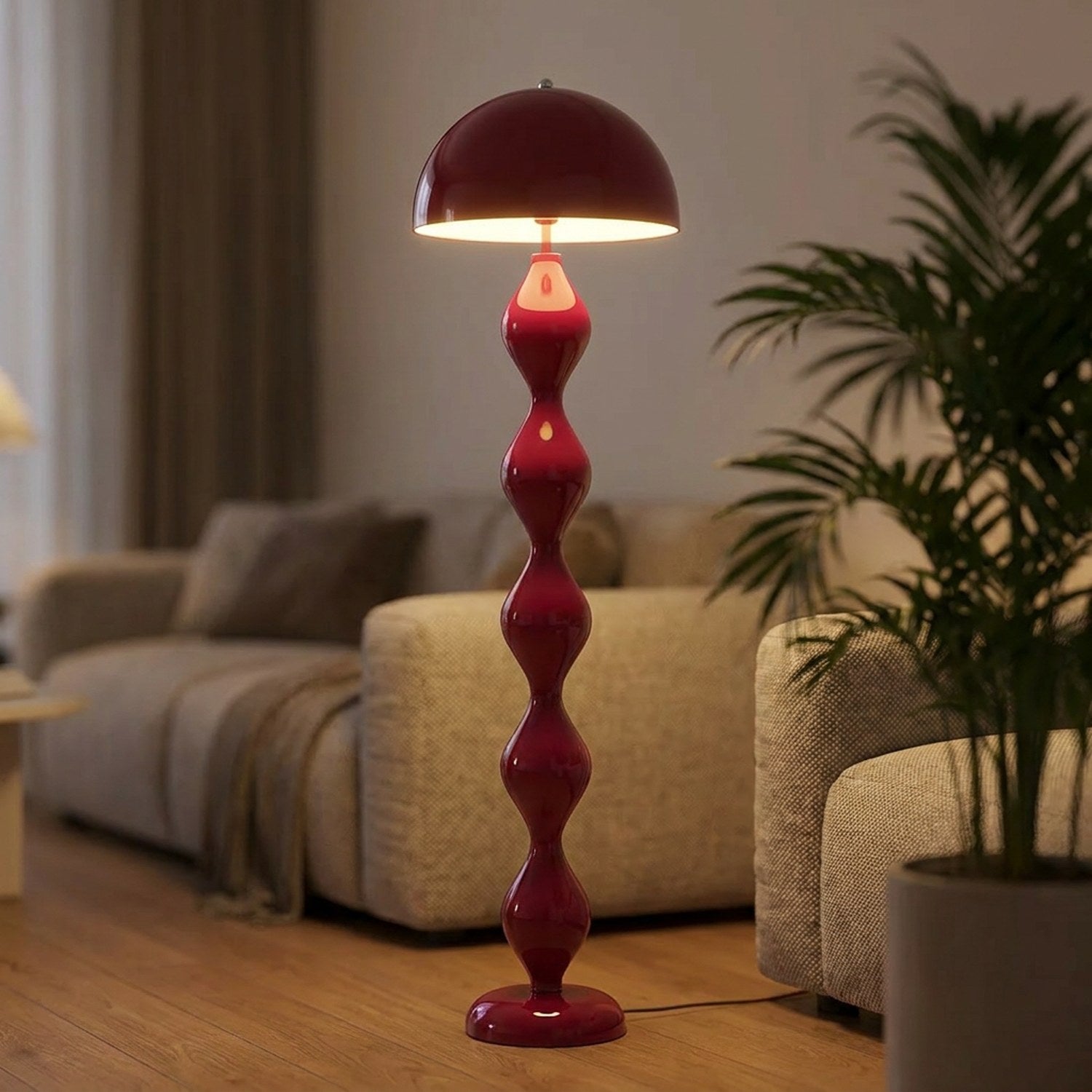 Lampadaire champignon rouge allumé près d'un canapé