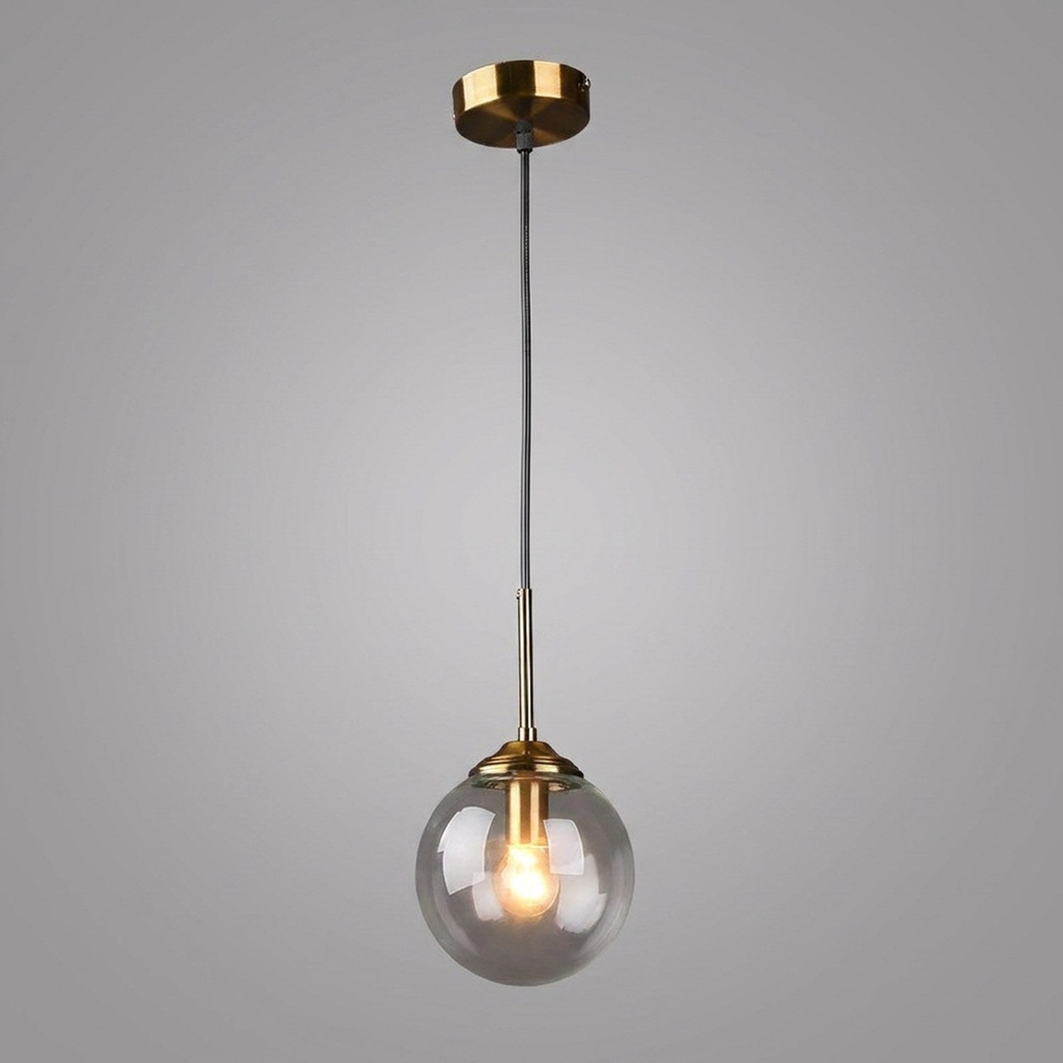 Suspension globe en verre transparent avec monture laiton dore