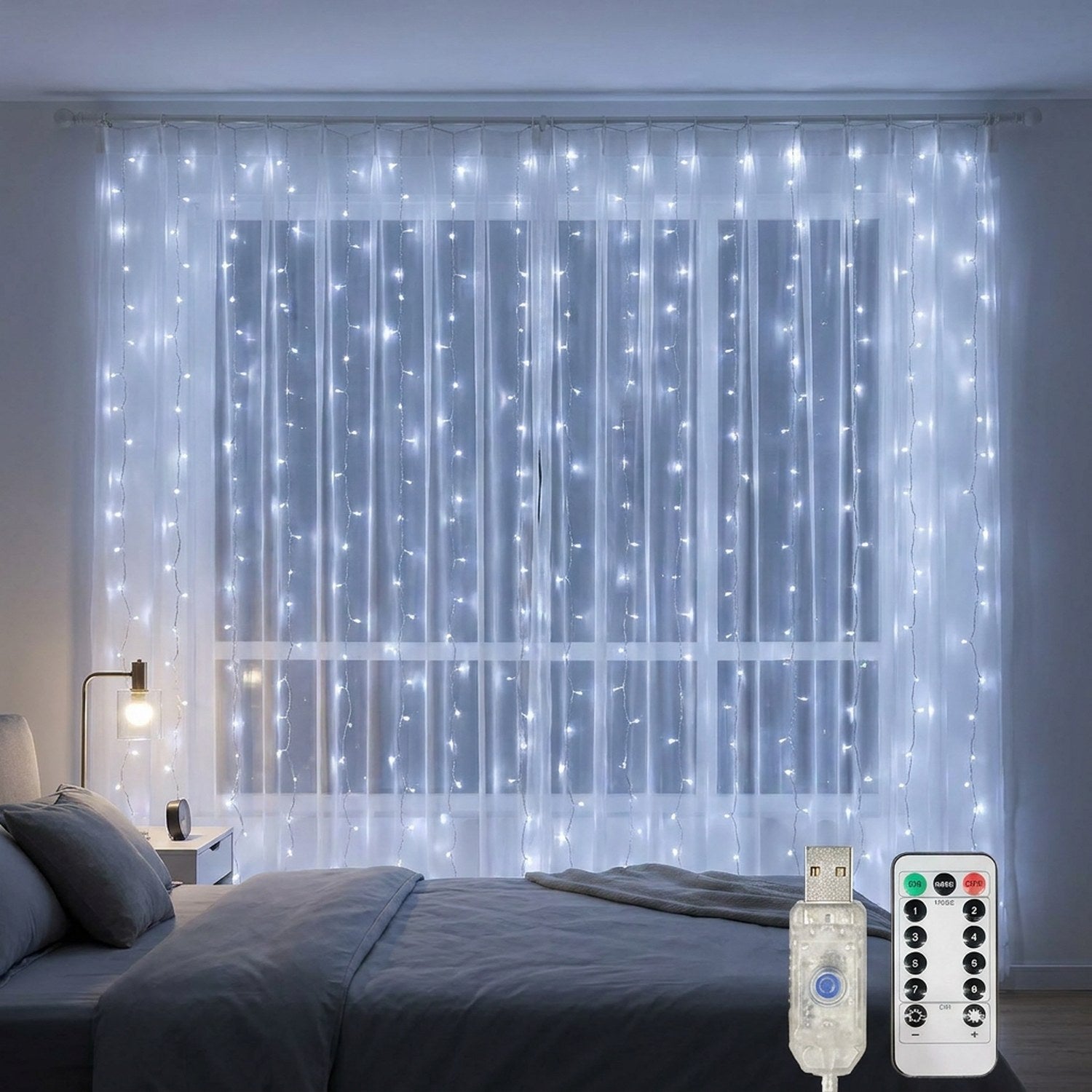 Rideau lumineux LED blanc froid suspendu à une fenêtre de chambre le soir