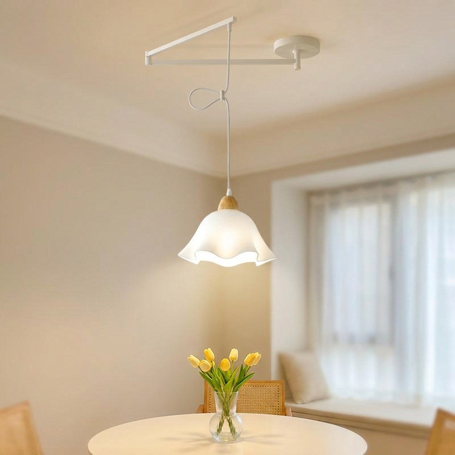 Lampe suspendue blanche, abat-jour fleur, au-dessus d'une table à manger