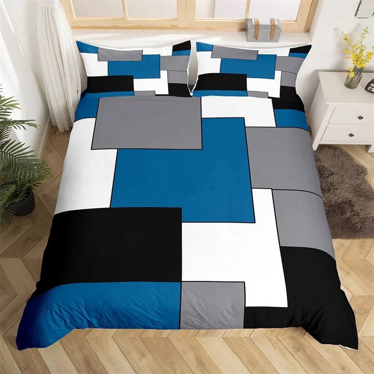 Parure de lit géométrique à blocs colorés bleus sur un lit dans une chambre moderne