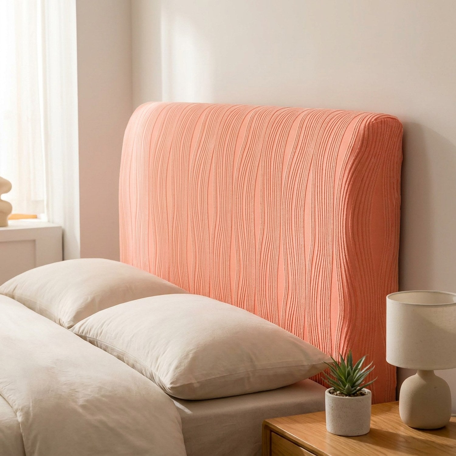 Housse de tête de lit corail en velours jacquard installée sur une tête de lit