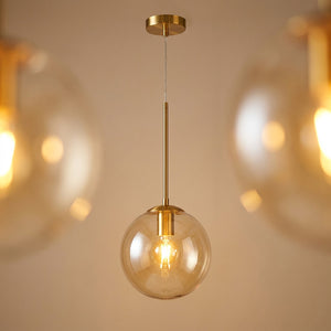 Suspension boule verre transparent finition dorée luminaire design