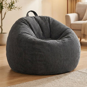 Housse de pouf poire en velours côtelé gris foncé dans un salon