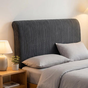Housse de tête de lit gris foncé en velours jacquard installée sur une tête de lit