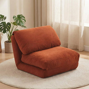 Fauteuil de sol pliable en velours côtelé terracotta dans un salon chaleureux