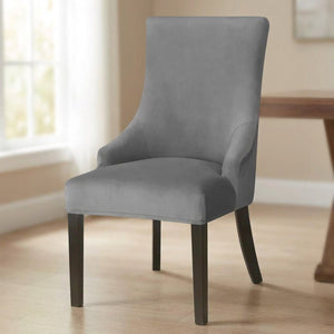 Housse de chaise grise en velours seule dans une salle à manger