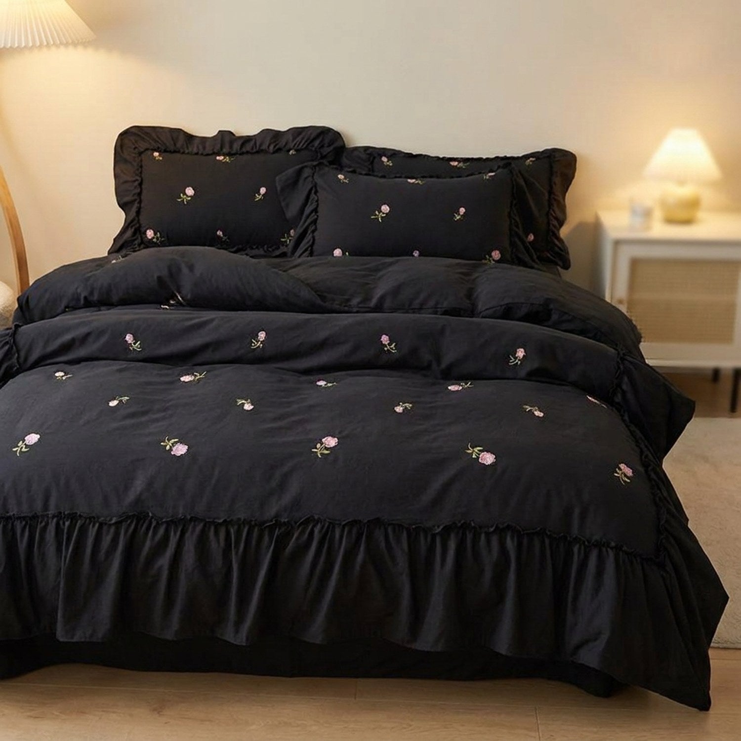 Parure de lit brodée de roses coloris noir gros plan sur le lit