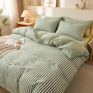 Housse de couette rayee verte et blanche posee sur un lit fait dans une chambre lumineuse