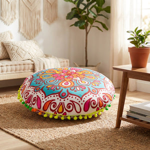 Housse de coussin ronde motif mandala multicolore posée sur un tapis bohème