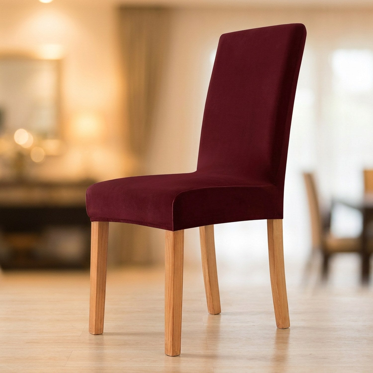 Housse de chaise grenat en velours moelleux sur une chaise de salle à manger