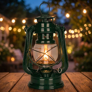 Lanterne à pétrole vintage en métal vert foncé avec sa flamme allumée